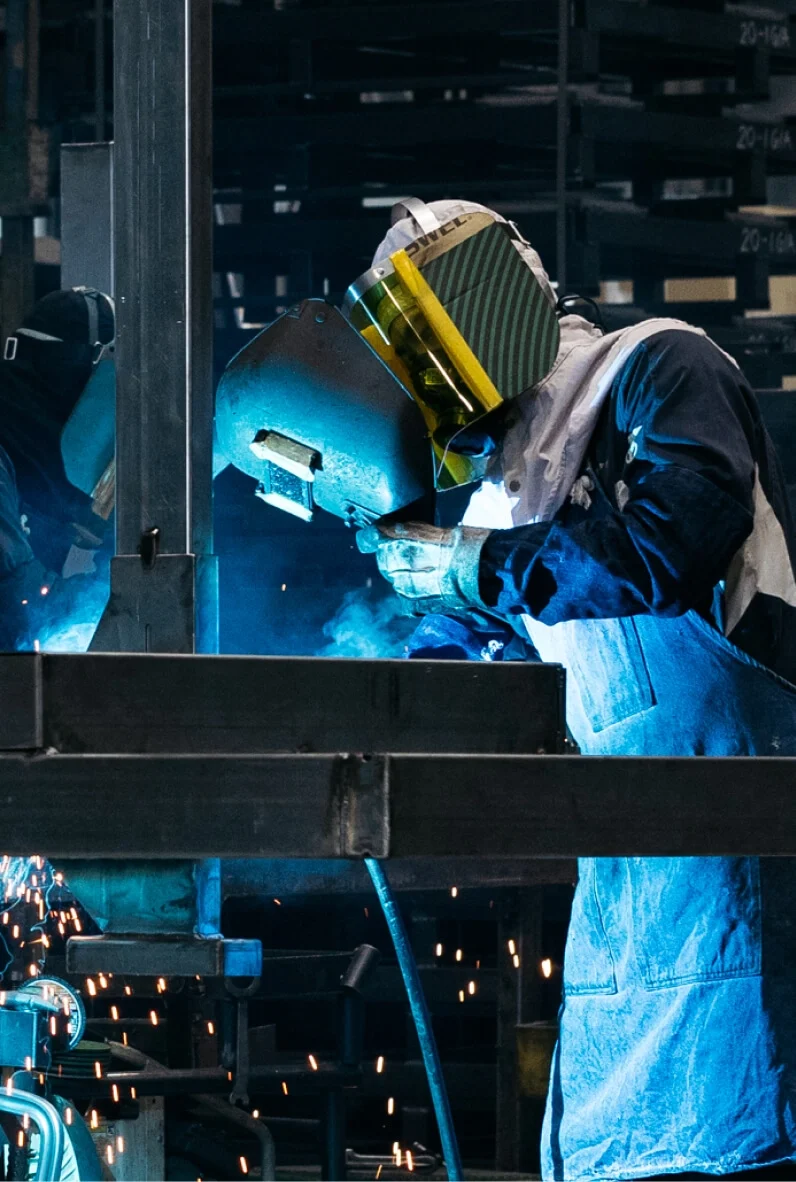 工場内で溶接作業を行う製造スタッフ