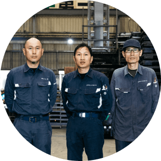 工場内で作業着を着た複数人の男性